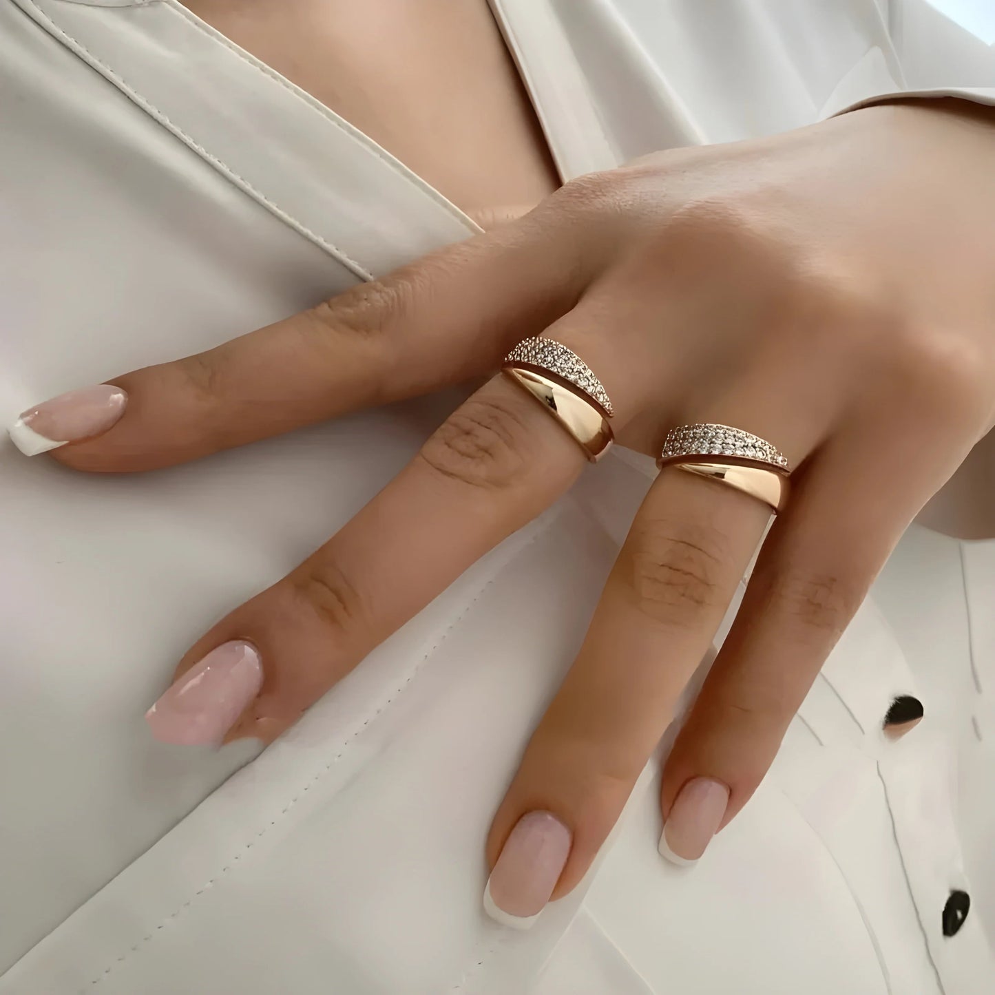 Gold-tone pavé band ring with two sparkling rows, worn on a hand