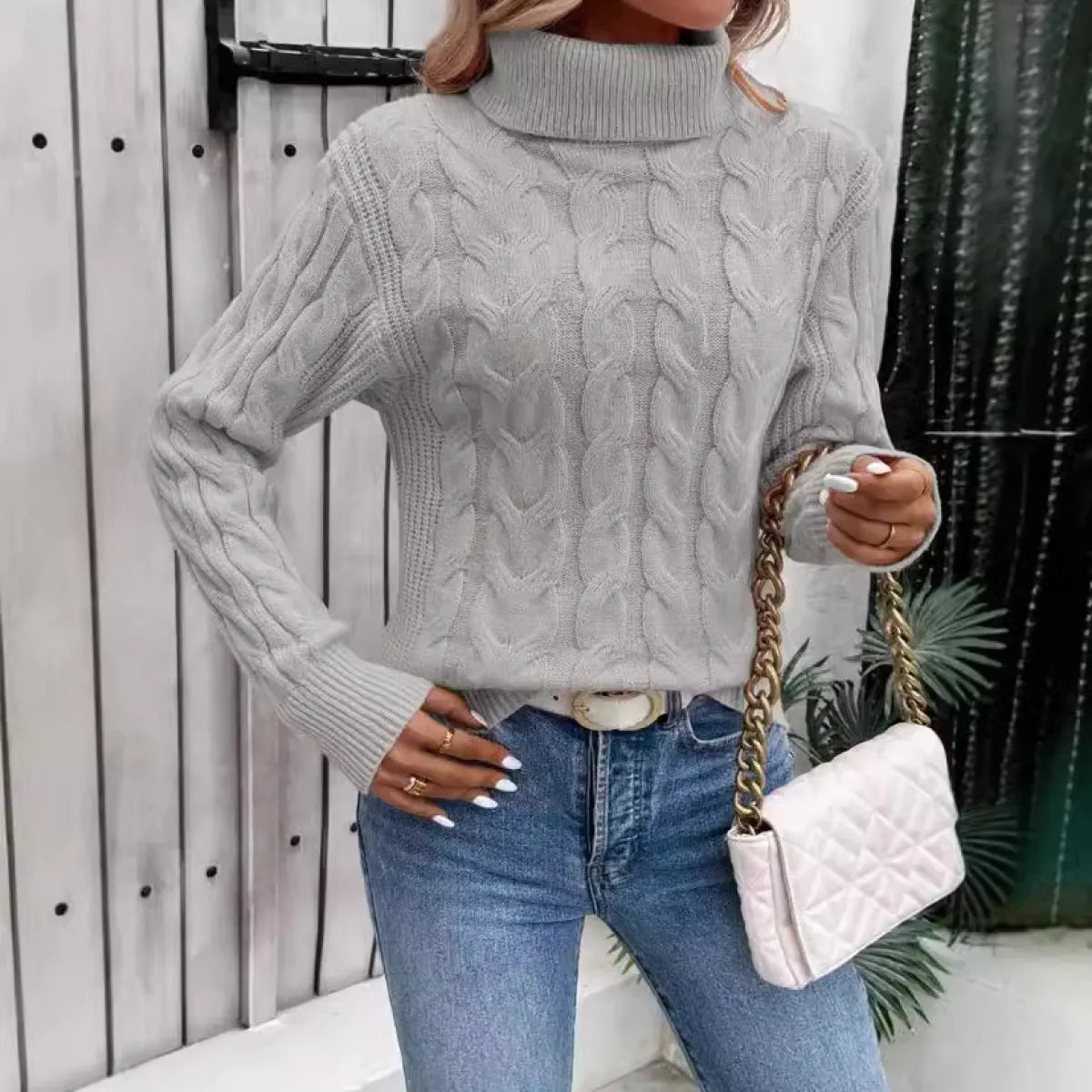 Light gray cable-knit turtleneck sweater with textured cable stitch