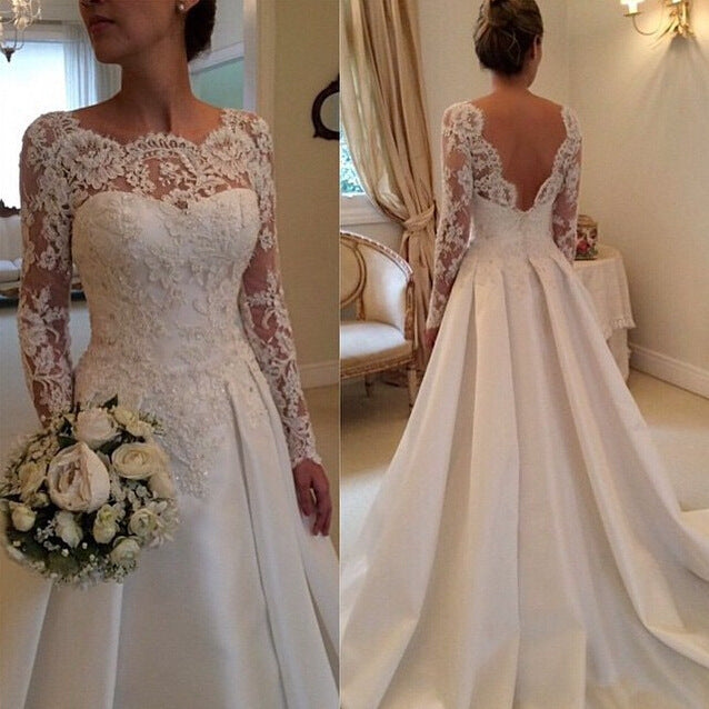 Ivory lace long-sleeve wedding dress front view with fitted bodice and full skirt